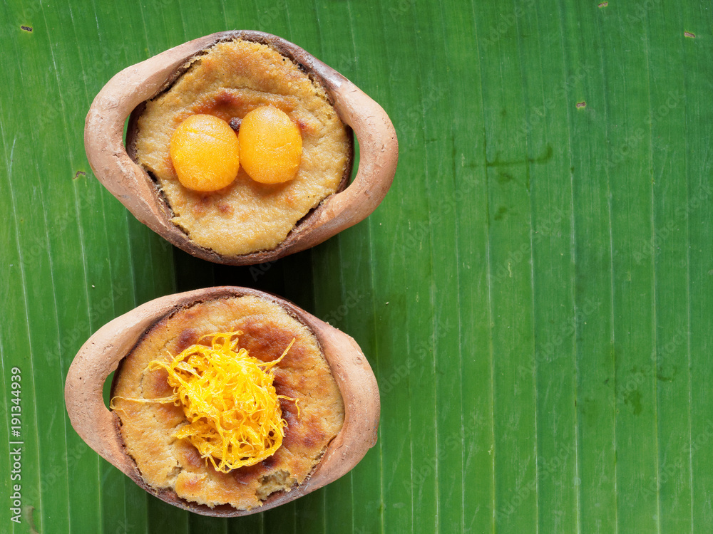 Thai coconut custard pudding dessert, Maw Gaeng, in clay pot on banana leaf background