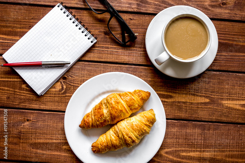 Business breakfast with coffee and croussant top view photo