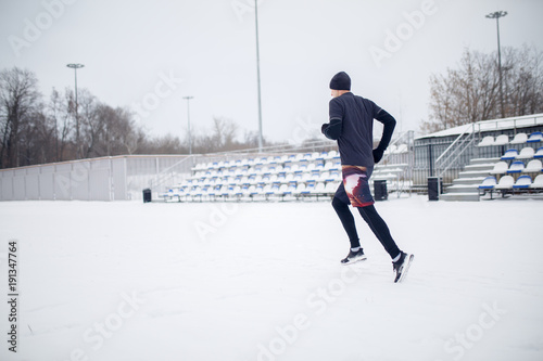 Image of running athlete through stadium