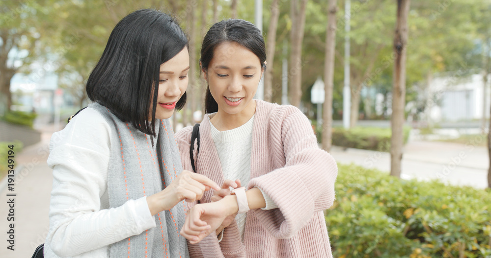 Friends finding shop location on smart watch at outdoor Friends finding shop location on smart watch at outdoor