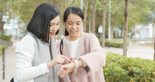 Fotografie Friends finding shop location on smart watch at outdoor