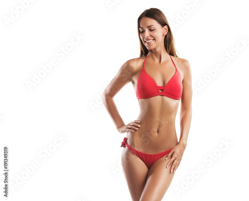 Fit young woman in a bikini isolated on white background