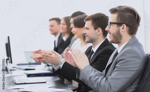 cheering business team sitting at Desk