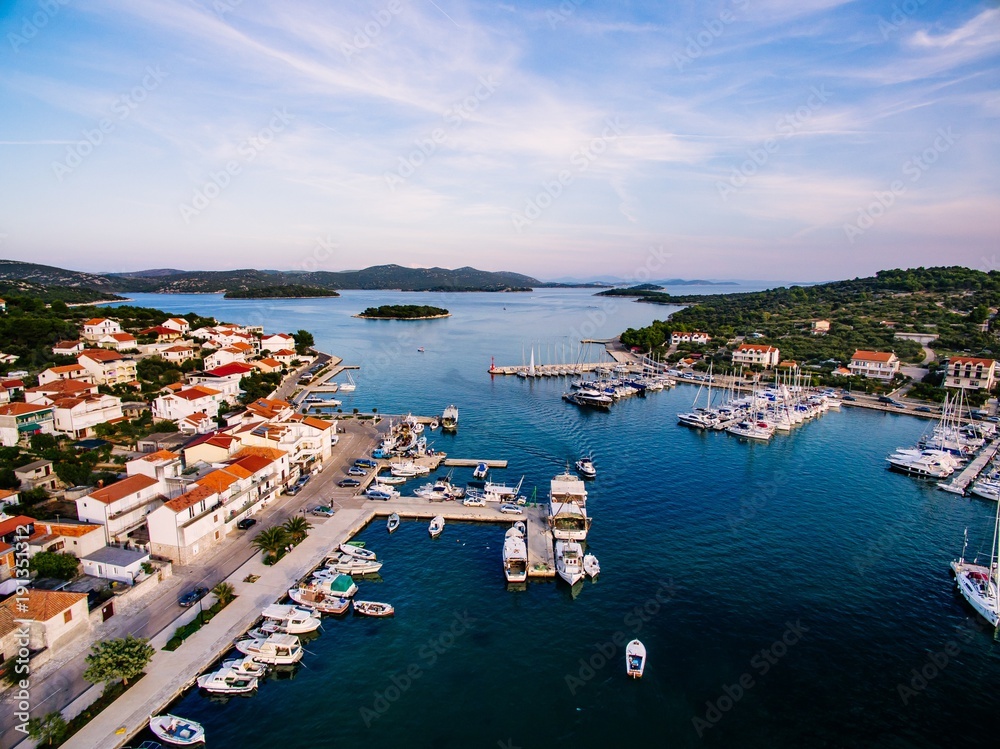 Aerial drone view of small marina with boats and yachts docked in Croatia