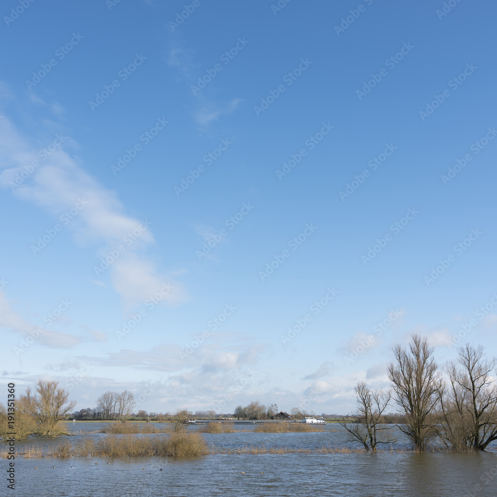 flooded flood plains of river ijssel and ship near Zalk between Kampen and Zwolle in the netherlands