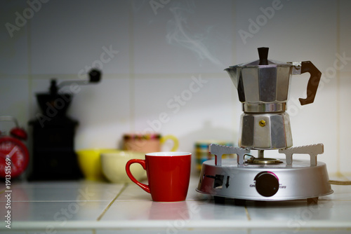 Metal coffee percolator with coffee cup prepare hot coffee photo