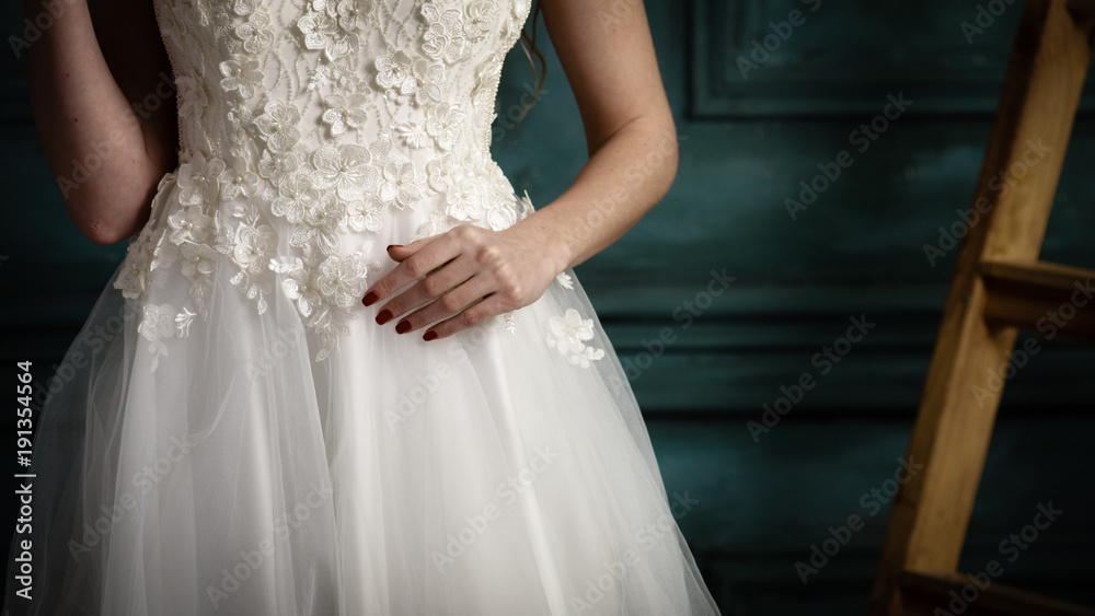 Bride in wedding dress. Closeup of bride in stylish white wedding dress posing