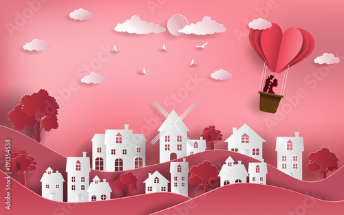Cute couple in love hugging, staring at each other's eyes and standing inside a basket of an air balloon, paper art style, flat-style vector illustration.