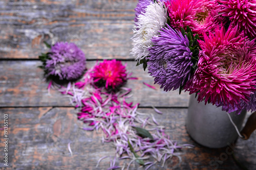 Fototapeta Naklejka Na Ścianę i Meble -  Aster flowers bouquet purple red pink white on a wooden background. selective focus