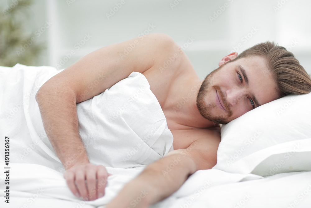 happy man, falling asleep in a comfortable bed happy man, falling asleep in a comfortable bed