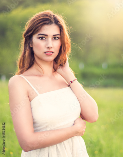 фотографія Young happy attractive woman posing in sunset
