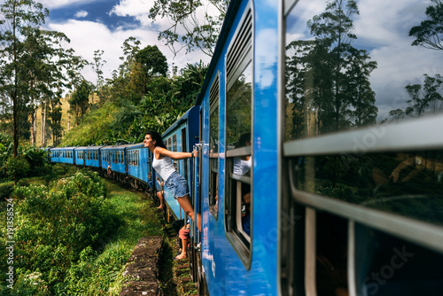 The girl travels by train to beautiful places. Beautiful girl traveling by train among mountains. Travel by train. Travelling to Asia. Trains Sri Lanka. Railway transport. Railway. Transport Asia