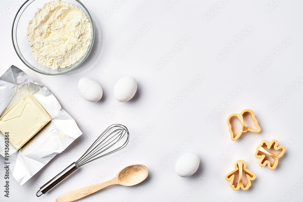 Preparation of the dough. Ingredients for the dough - flour, butter, eggs and various tools. On white background. Free space for text . Top view Preparation of the dough. Ingredients for the dough - flour, butter, eggs and various tools. On white background. Free space for text . Top view