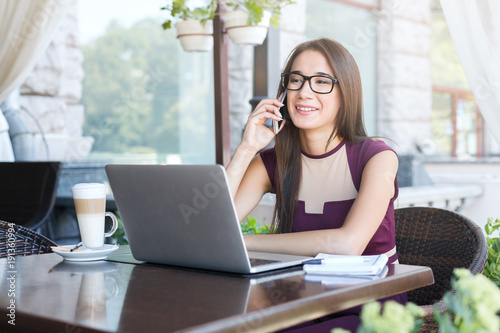 Young businesswoman talking on phone in cafe Free Download Young businesswoman talking on phone in cafe - GFXLoad