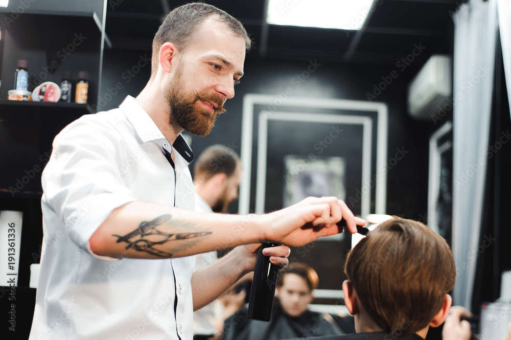 cute young boy getting a haircut