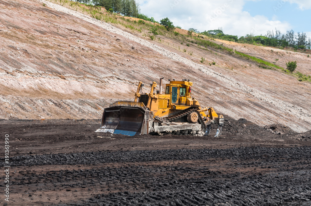 Mining Equipment or Mining Machinery, Bulldozer, wheel loader, shovels, loading of coal, ore on the dump truck from open-pit or open-cast mine as the Coal Production. Mining Equipment or Mining Machinery, Bulldozer, wheel loader, shovels, loading of coal, ore on the dump truck from open-pit or open-cast mine as the Coal Production.