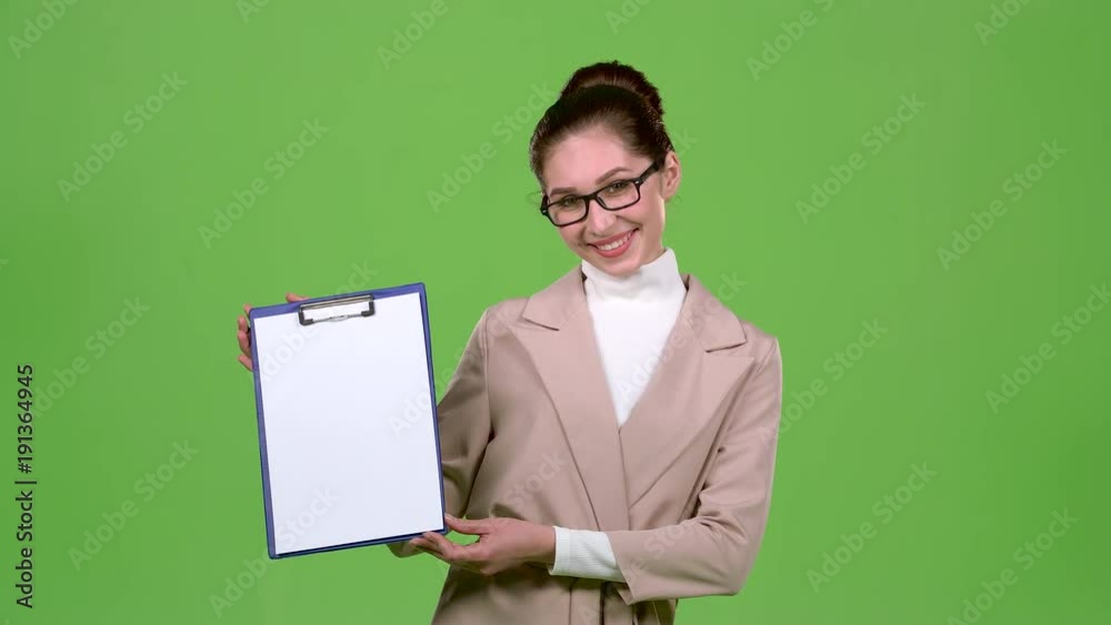 Girl advertising agent shows important information on the tablet. Green screen. Slow motion Girl advertising agent shows important information on the tablet. Green screen. Slow motion