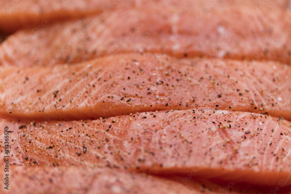 Fresh raw salmon fish fillet background with pepper