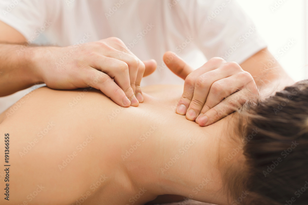 Woman getting classical back and neck massage Woman getting classical back and neck massage