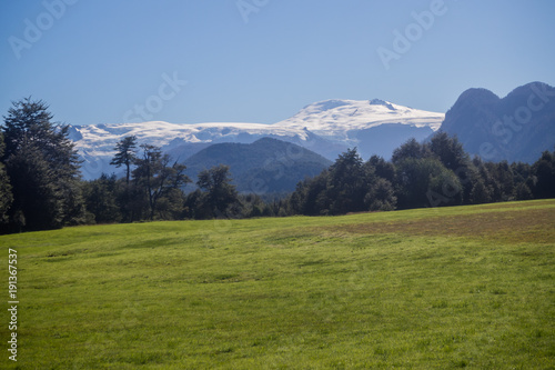 Chilean Patagonia landscape in the Pumalin Natural Park in summer with a snowy volcano