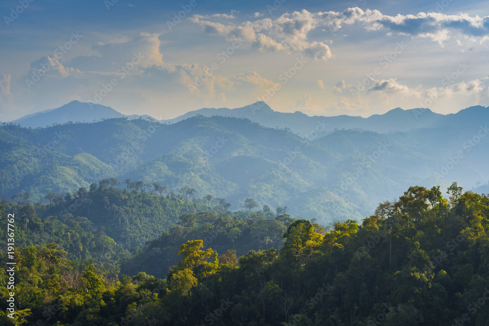 Light on ridge with mountain range and blue sky background Light on ridge with mountain range and blue sky background