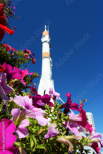 monument of space cosmic rocket in the Samara, Russia. View across petunia flowerbed