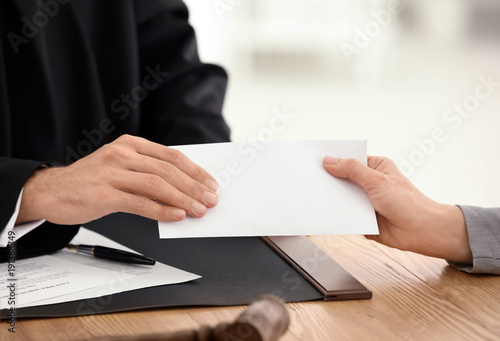 Male judge taking bribe from woman, closeup