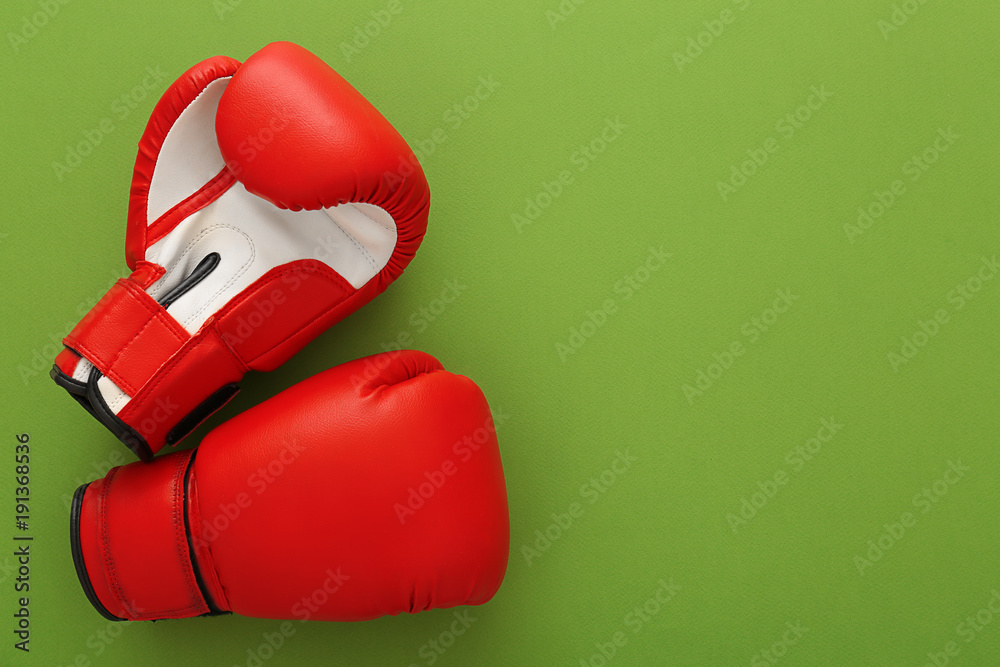 Boxing gloves with blank space for gym exercise plan on color background. Flat lay composition