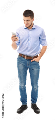 Young man using cell phone ...