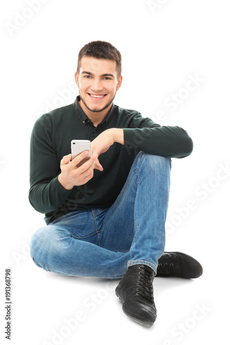Young man using cell phone ...