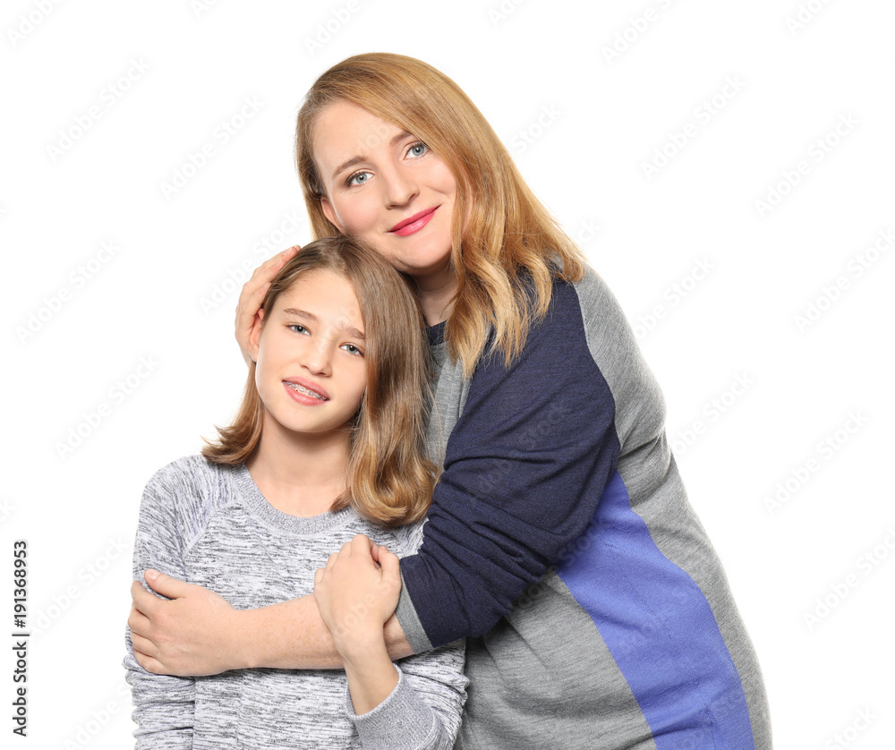 Happy mother and daughter hugging on white background Happy mother and daughter hugging on white background