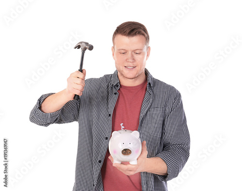 Young man holding hammer ov...