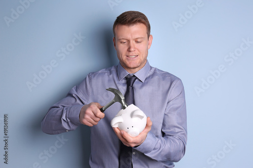 Young man holding hammer ov...