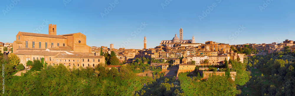 Scenery of Siena, a beautiful medieval town in Tuscany, with view of the Dome & Bell Tower of Siena Cathedral (Duomo di Siena), landmark Mangia Tower and Basilica of San Domenico, Italy