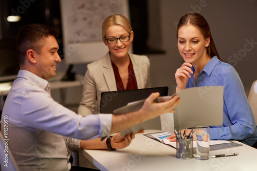 business team with papers working late at office