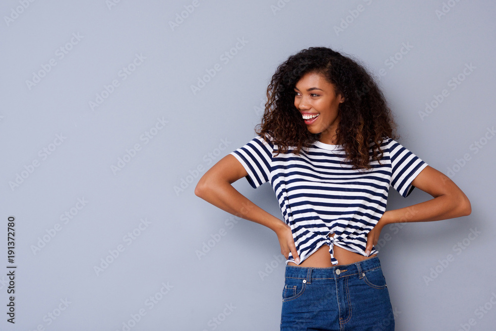 attractive young african woman smiling against gray background attractive young african woman smiling against gray background