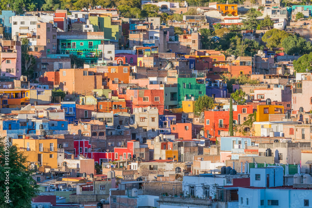 Isolated shot of many colorful houses, dotting the hillside, on a sunny day, In Guanajuato, Mexico