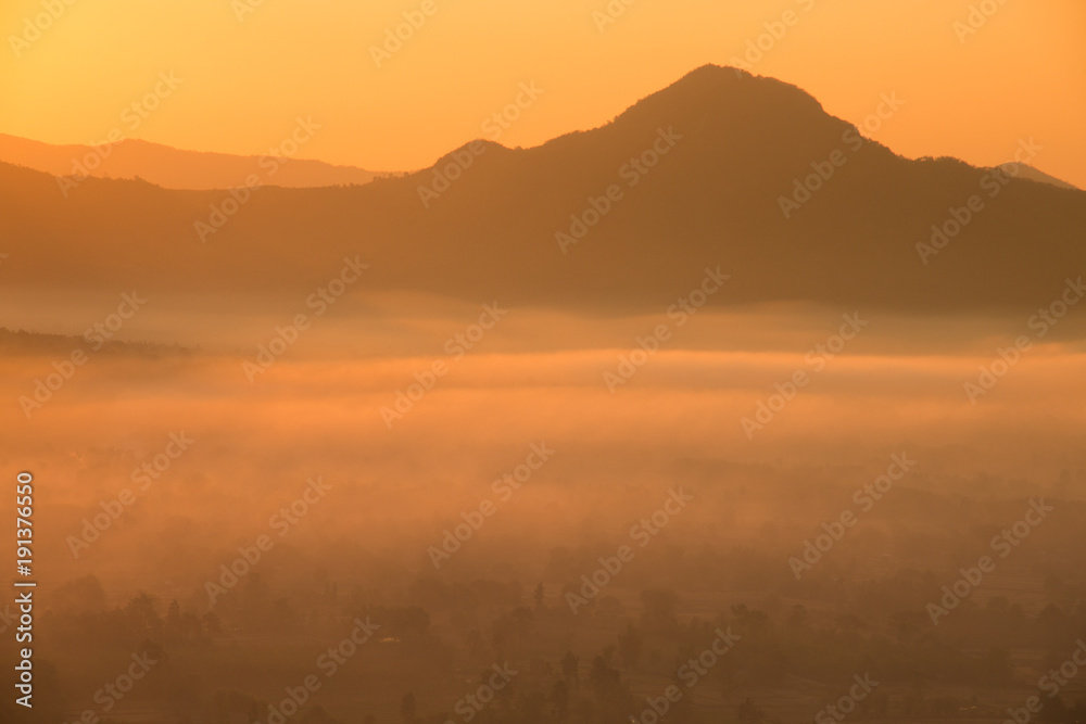 Beautiful sunrise :silhouette of the mountain with foggy at morning.