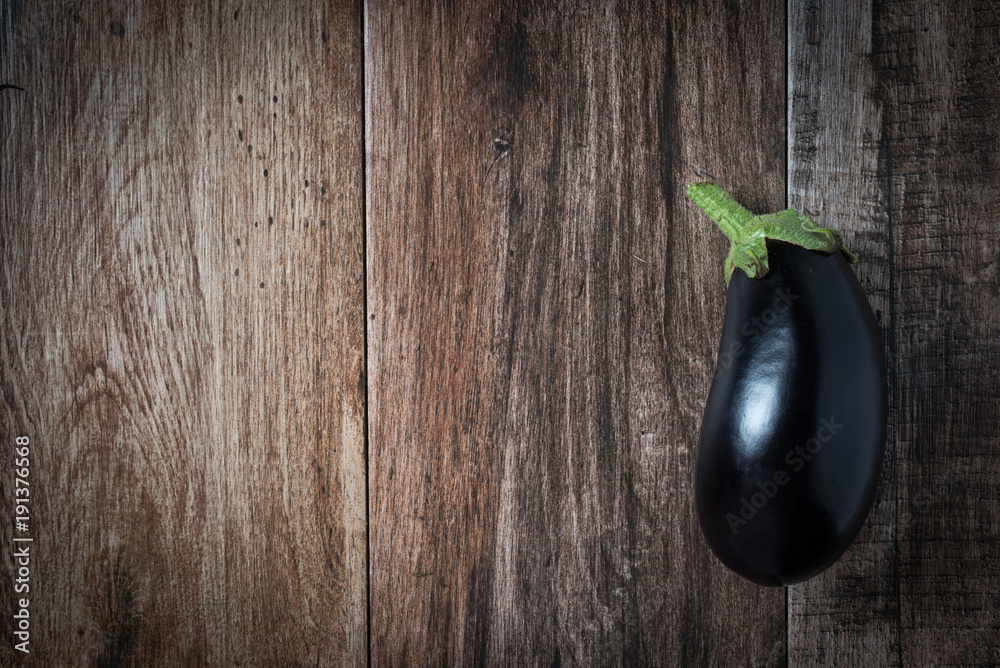 Shiny Eggplant on rustic wooden bacground. Copy space. Shiny Eggplant on rustic wooden bacground. Copy space.