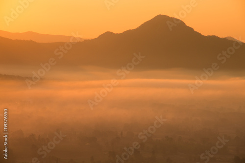 Beautiful sunrise :silhouette of the mountain with foggy at morning.