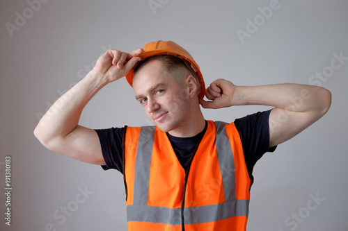 smiling builder worker in orange protectiive cask photo