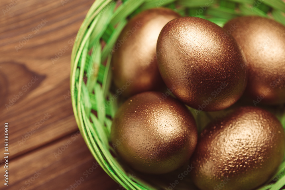 gold eggs on wooden table gold eggs on wooden table