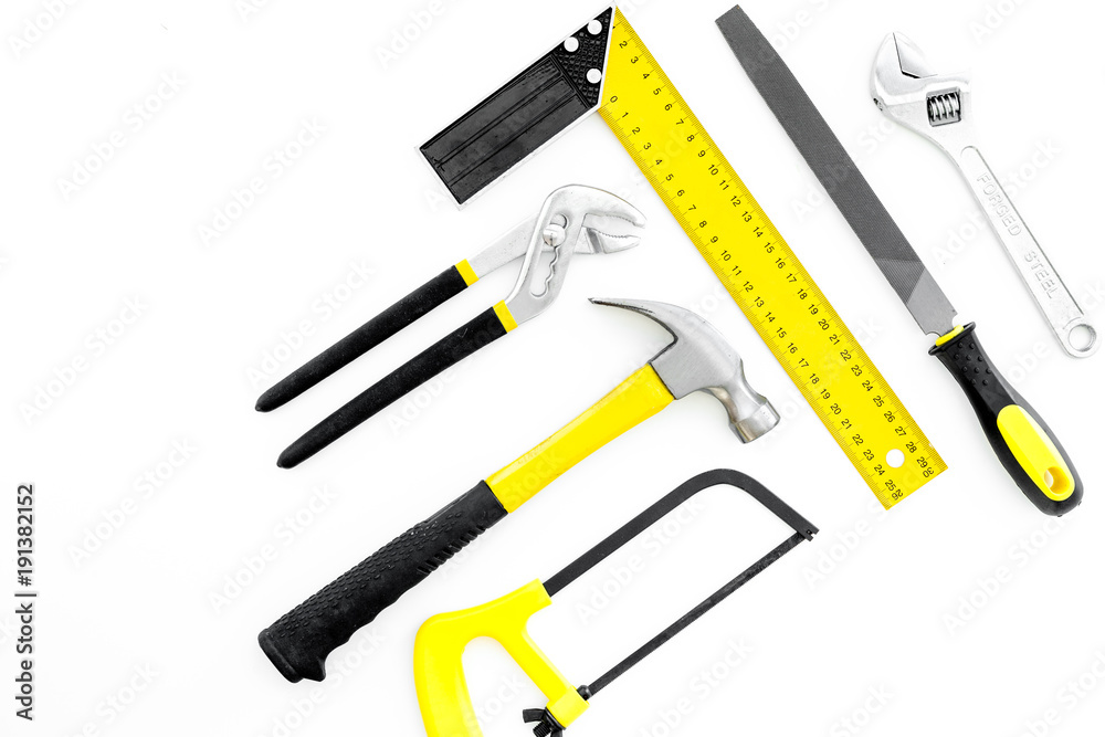 Tools for repair and building. Hummer, file, corner ruler, saw on white background top view copy space
