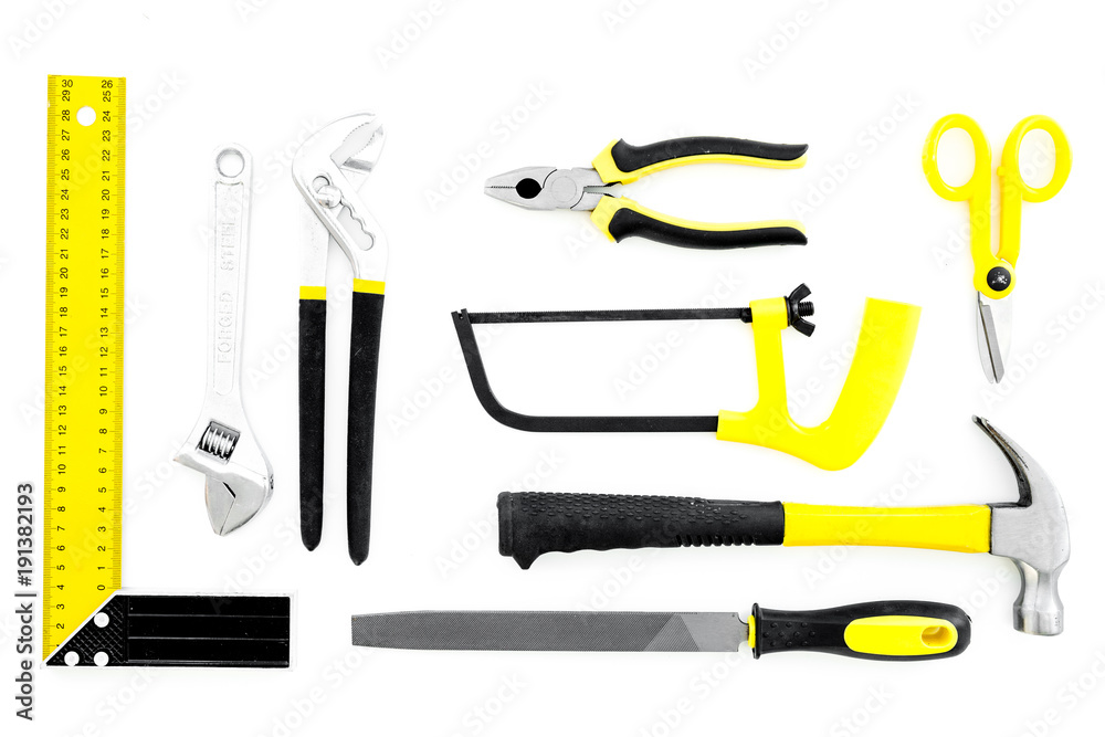 Repair tool kit. File, saw, hummer, corner ruler on white background top view pattern