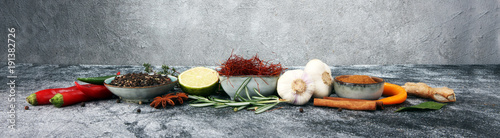 Spices and herbs on grey background. Food and cuisine ingredients.