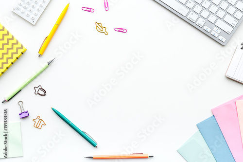 Creative mess on student's desk. Keyboard, notebook, stationery, on white background top view copy space