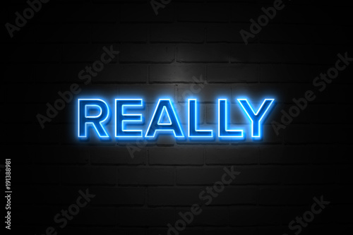 Really neon Sign on brickwall photo