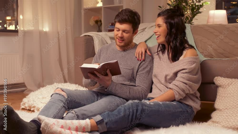 happy couple reading book at home happy couple reading book at home