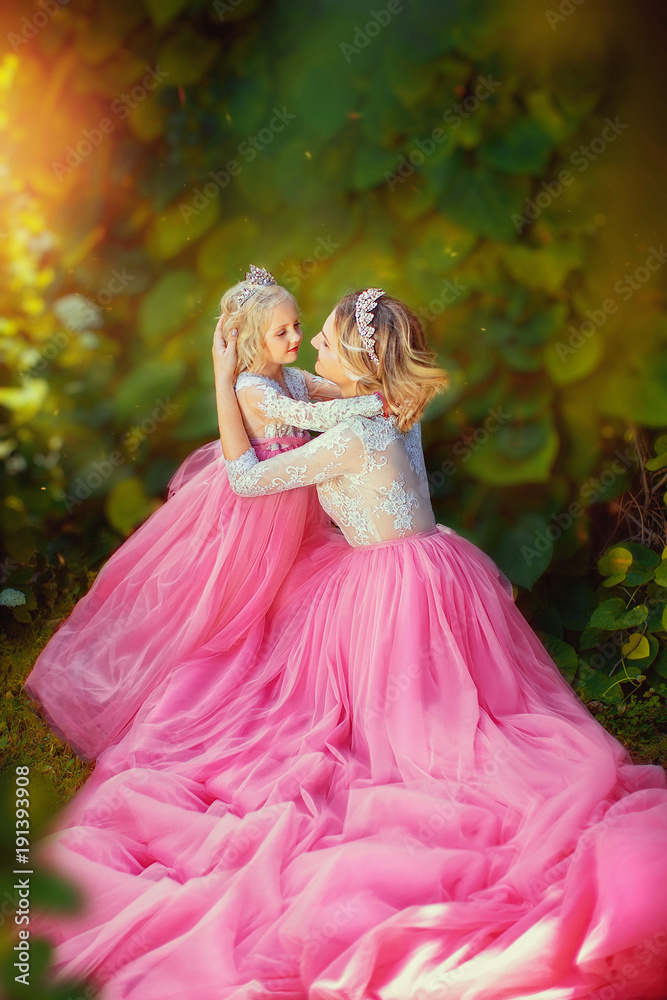 Beautiful princess in pink dresses, in summer park