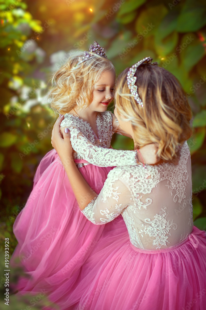 Beautiful princess in pink dresses, in park